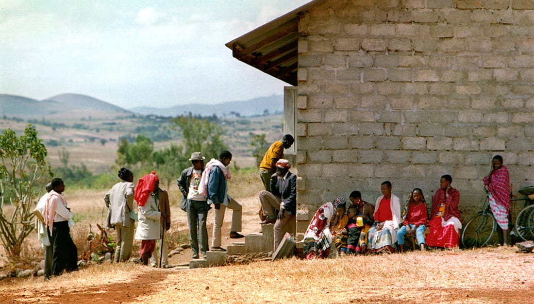 <em>Patients line up to receive medical screenings outside a makeshift clinic in Tanzania. © Photo by James Ketsdever</em>